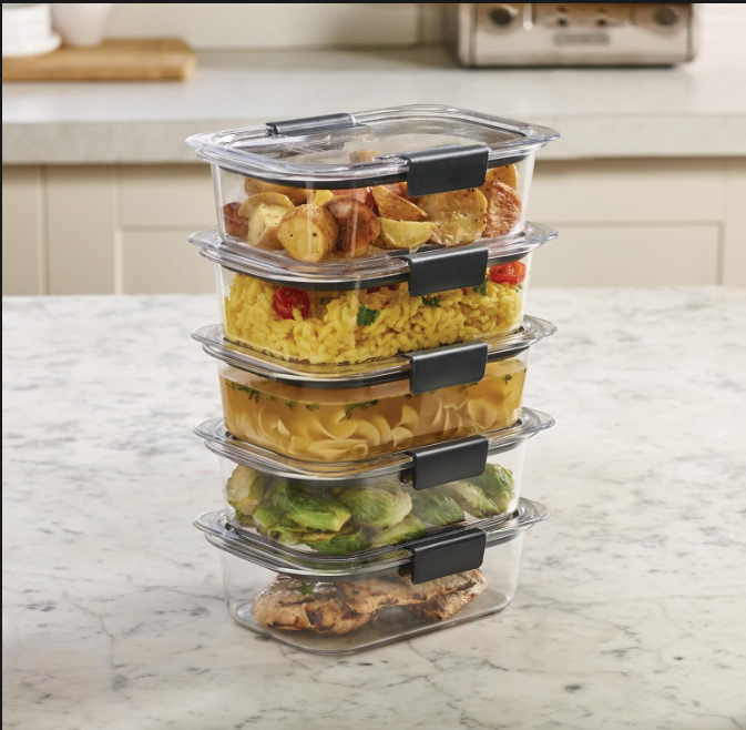 Five stackable food storage containers with locking lids used for organized meal prep and kitchen storage.