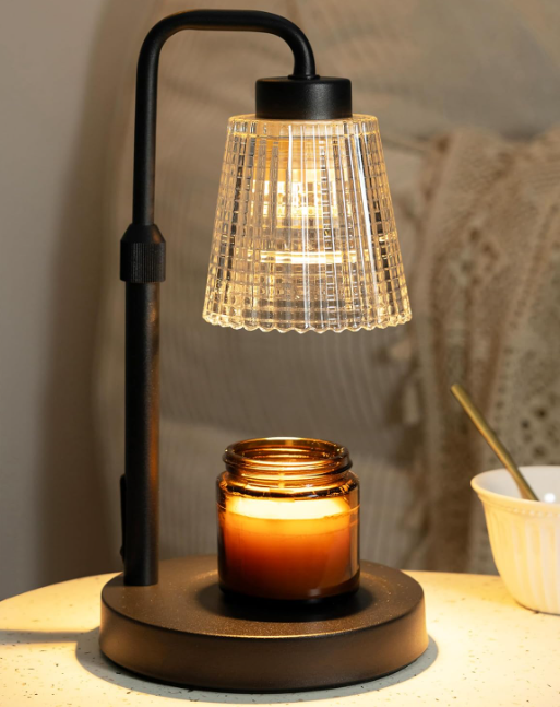 Black candle warmer lamp gently warming a jar candle